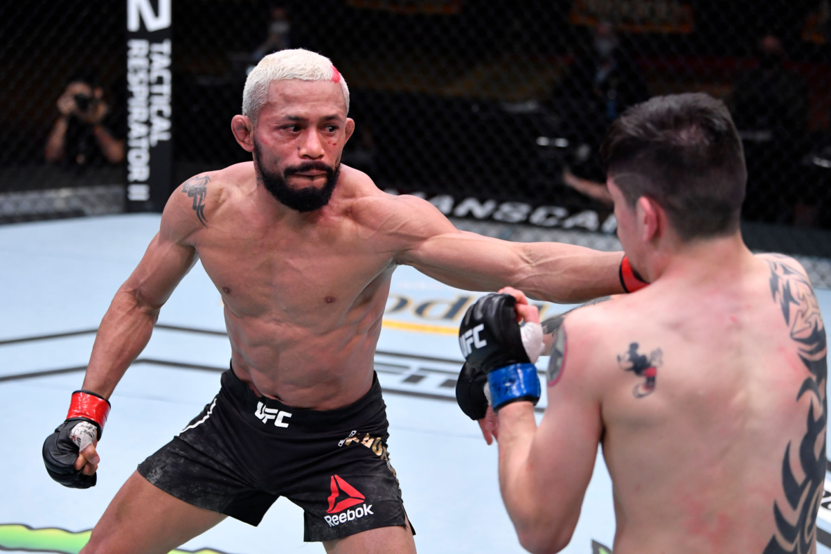 LDeiveson Figueiredo of Brazil punches Brandon Moreno during UFC 256