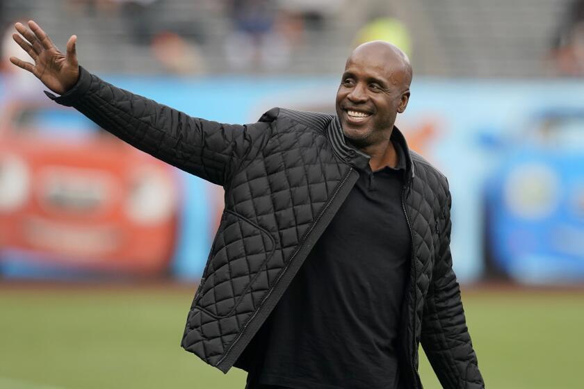 Former San Francisco Giants player Barry Bonds waves as he arrives at a ceremony honoring Hunter Pence.