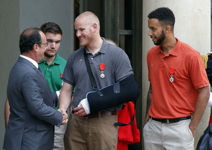 Then-French President Francois Hollande bids farewell to three Americans who stopped a terrorist attack on a train in 2015.