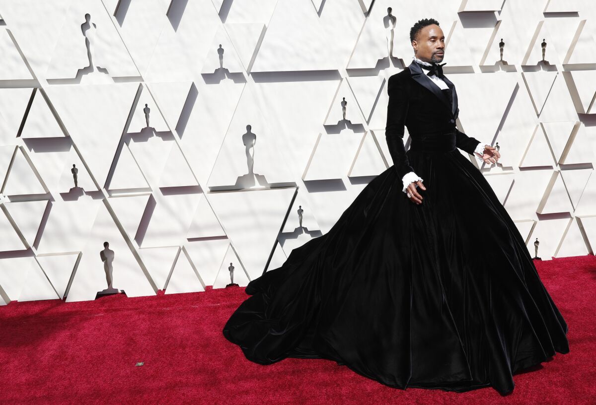 Billy Porter on the Oscars red carpet in an outfit that is tuxedo meets ball gown.