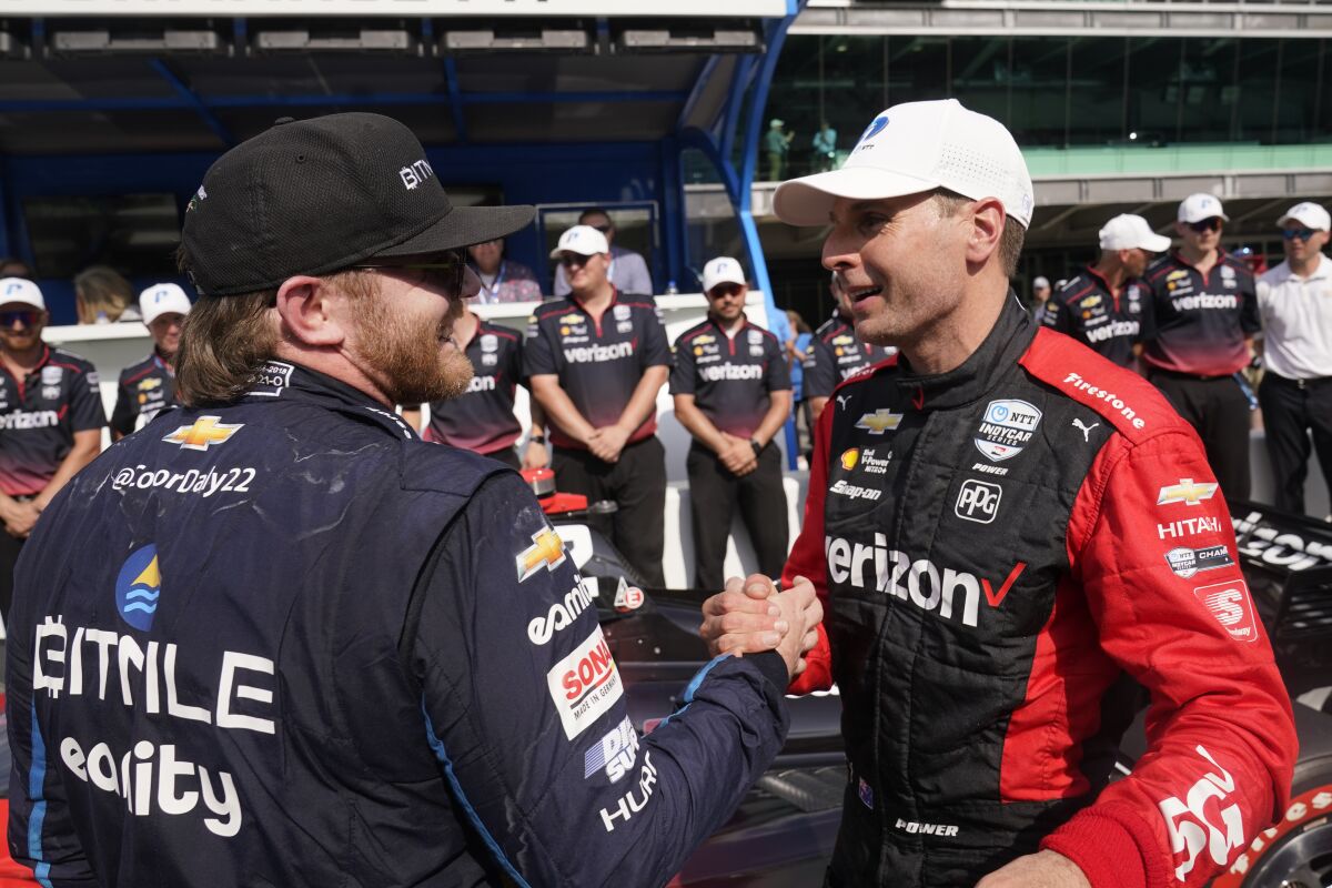 Will Power, right, of Australia, is congratulated by Conor Daly after Power won the pole for the IndyCar auto race at Indianapolis Motor Speedway, Friday, May 13, 2022, in Indianapolis. (AP Photo/Darron Cummings)