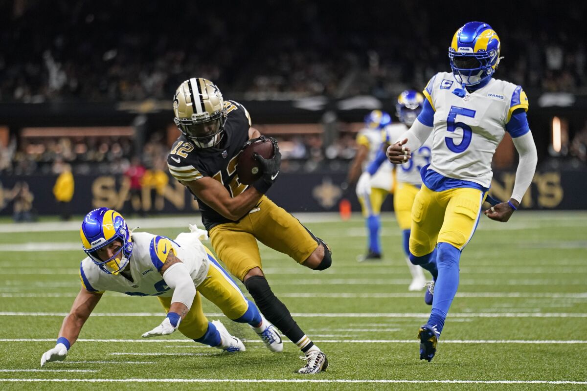  Saints wide receiver Chris Olave catches a 53-ayrd touchdown pass as  Los  Rams cornerback Jalen Ramsey (5) can't keep pace.