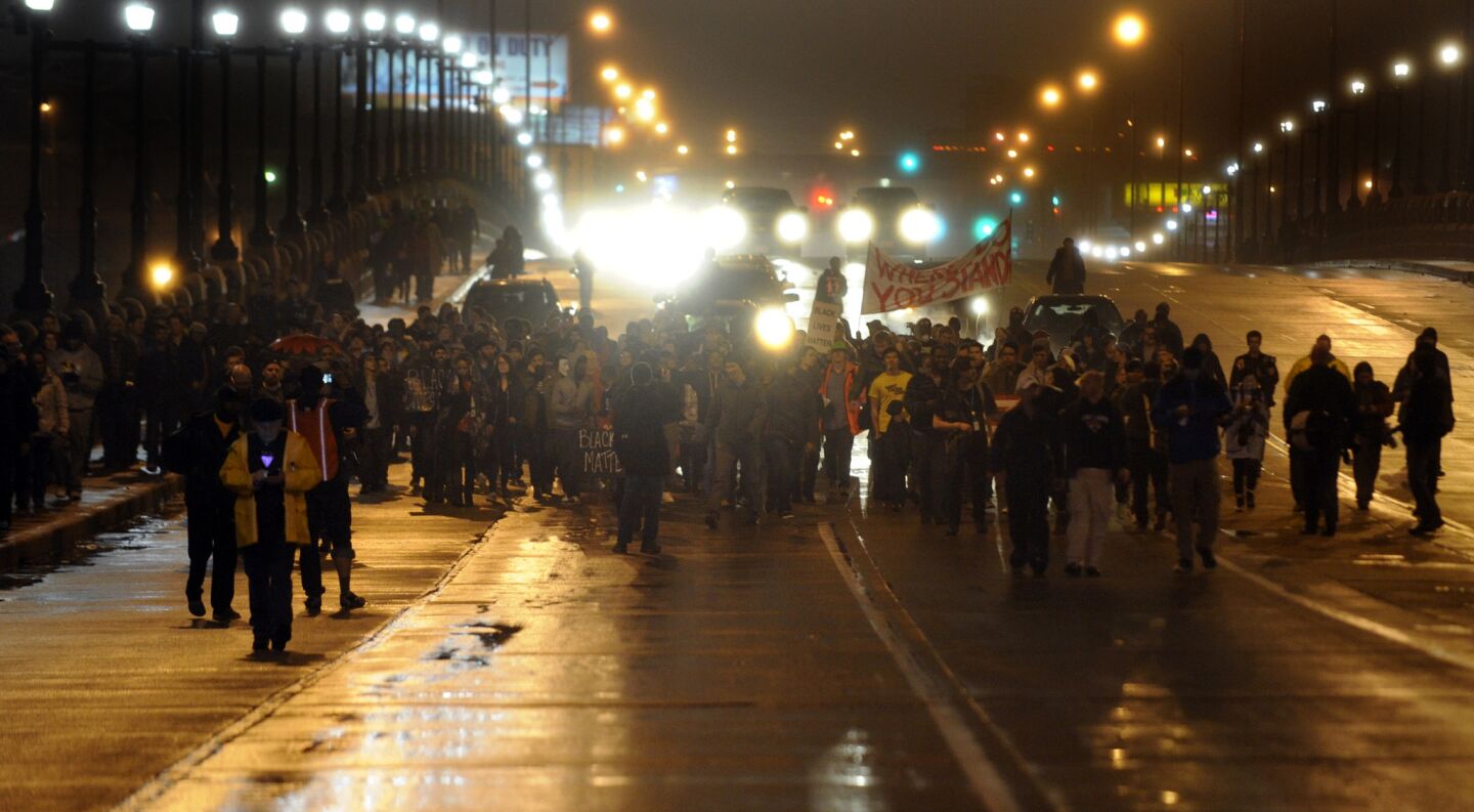 Protesters march down Kingshighway Boulevard during a demonstration in St. Louis, Mo., on Nov. 23.