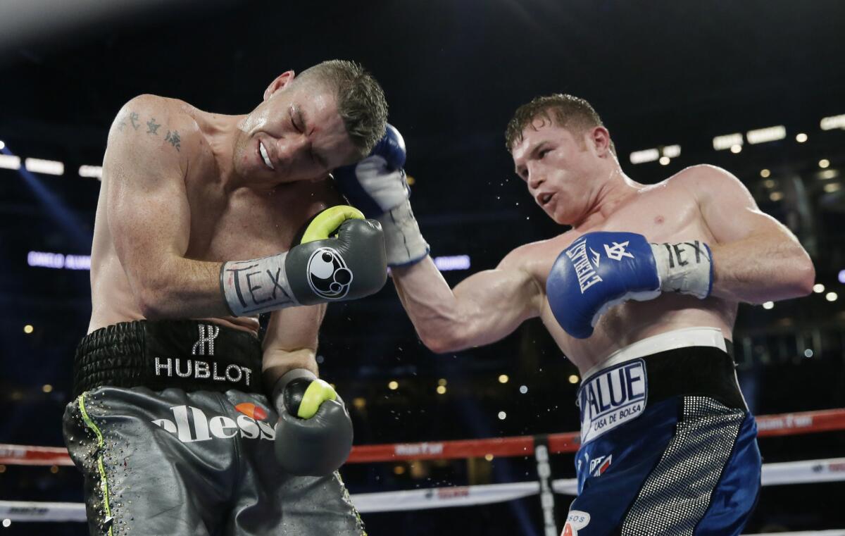 Canelo Alvarez, right, lands a right against Liam Smith during the ninth round of their fight on Sept. 17 at AT&T Stadium in Arlington, Texas.