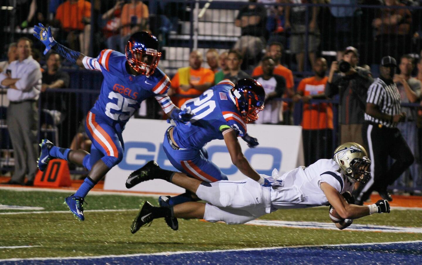 St. John Bosco tight end Jarett Balter scores on a pass play against Bishop Gorman defensive backs Jabari Butler (20) and Tyjon Lindsey (25) in the second half.