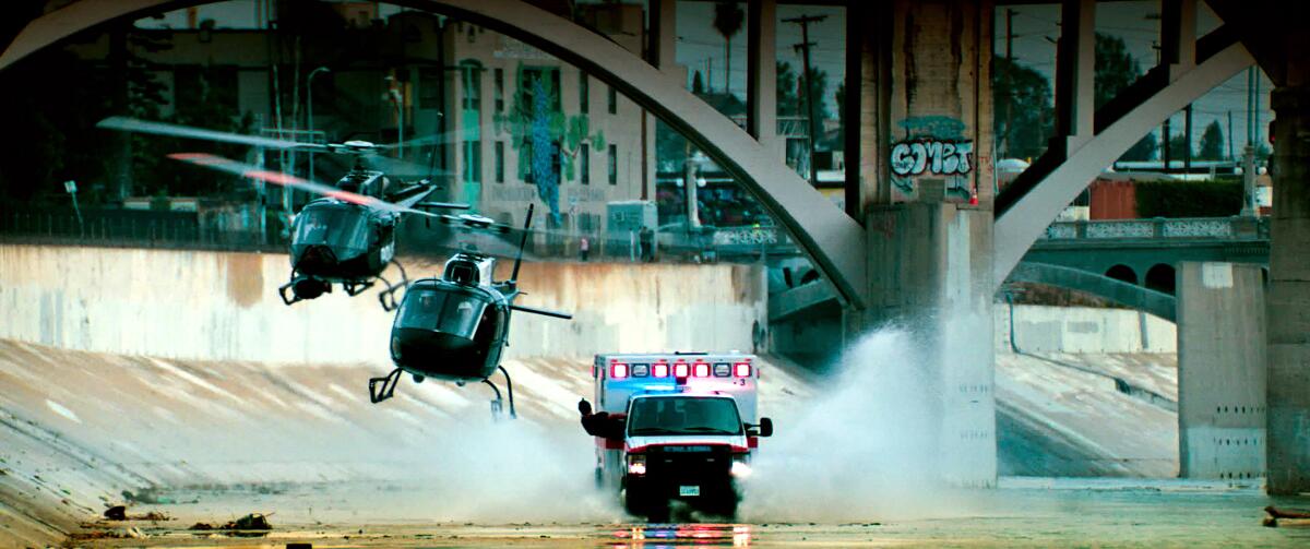Helicopter chase an ambulance under a bridge.
