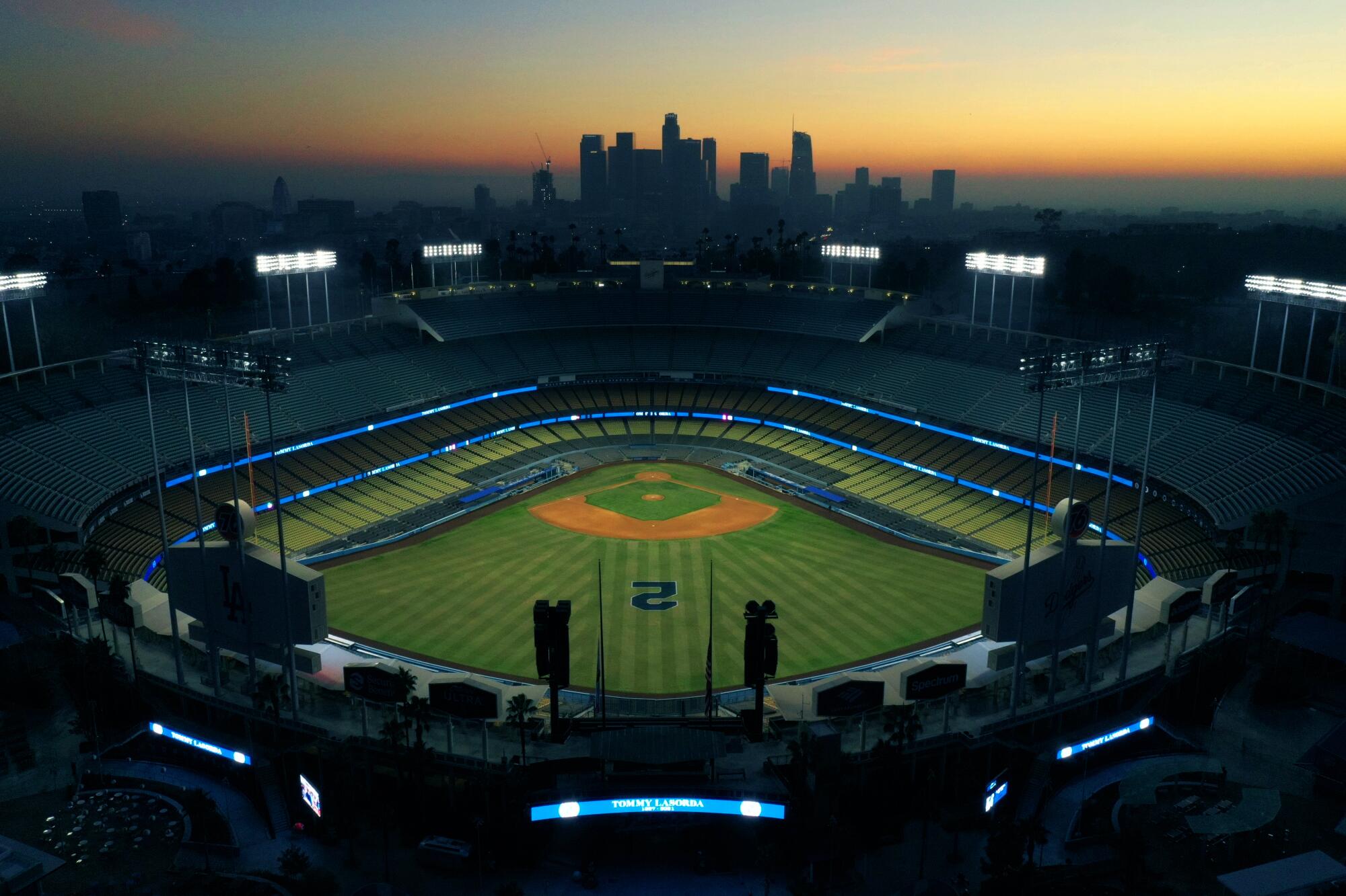 Dodger Stadium is lit in blue, with the L.A. skyline behind it.
