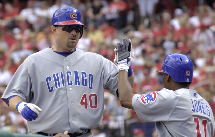 The Cubs' Phil Nevin (40) is congratulated by Jacque Jones after Nevin homered against the Cardinals on June 3, 2006.