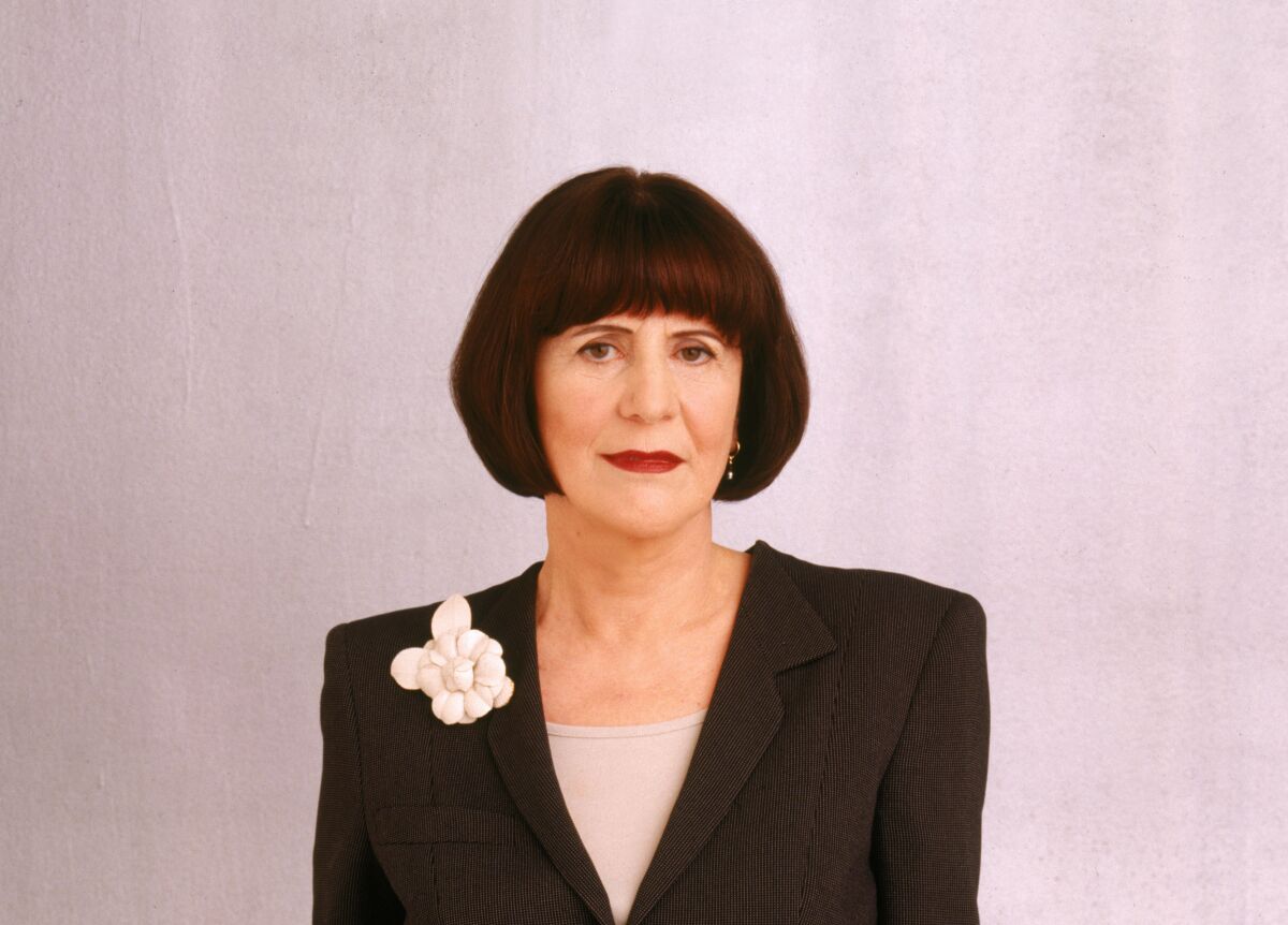 Elsa Klensch in a jacket with a floral decoration on a lapel