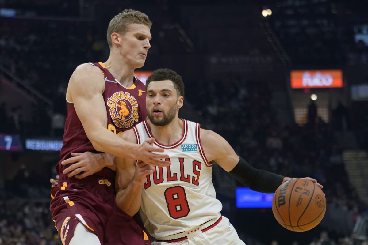 Chicago Bulls' Zach LaVine (8) drives against Cleveland Cavaliers' Lauri Markkanen (24) in the first half of an NBA basketball game, Wednesday, Dec. 8, 2021, in Cleveland. (AP Photo/Tony Dejak)