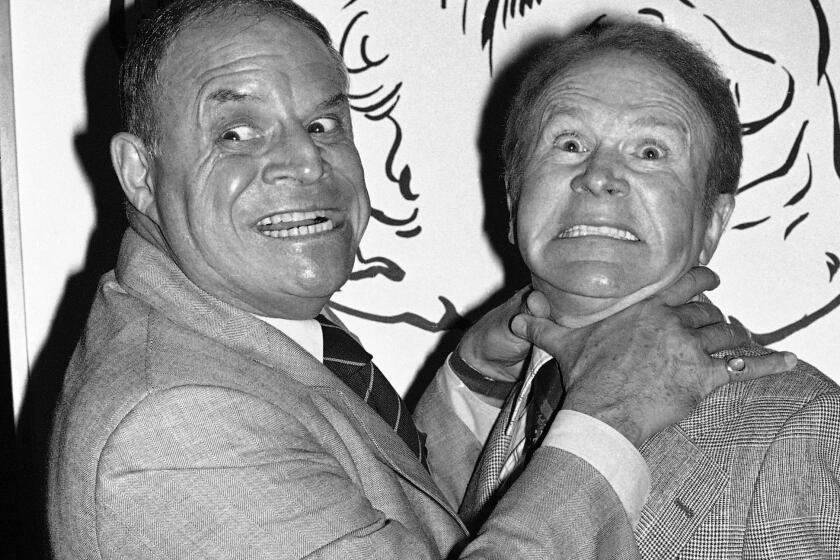 FILE - In this Nov. 10, 1977 file photo, comedian Don Rickles, left, pretends to strangle fellow comedian Red Buttons prior to an Annual Stag Roast in Los Angeles. Rickles died Thursday, April 6, 2017, of kidney failure at his Los Angeles home. He was 90. (AP Photo/ Lennox McLendon, File)