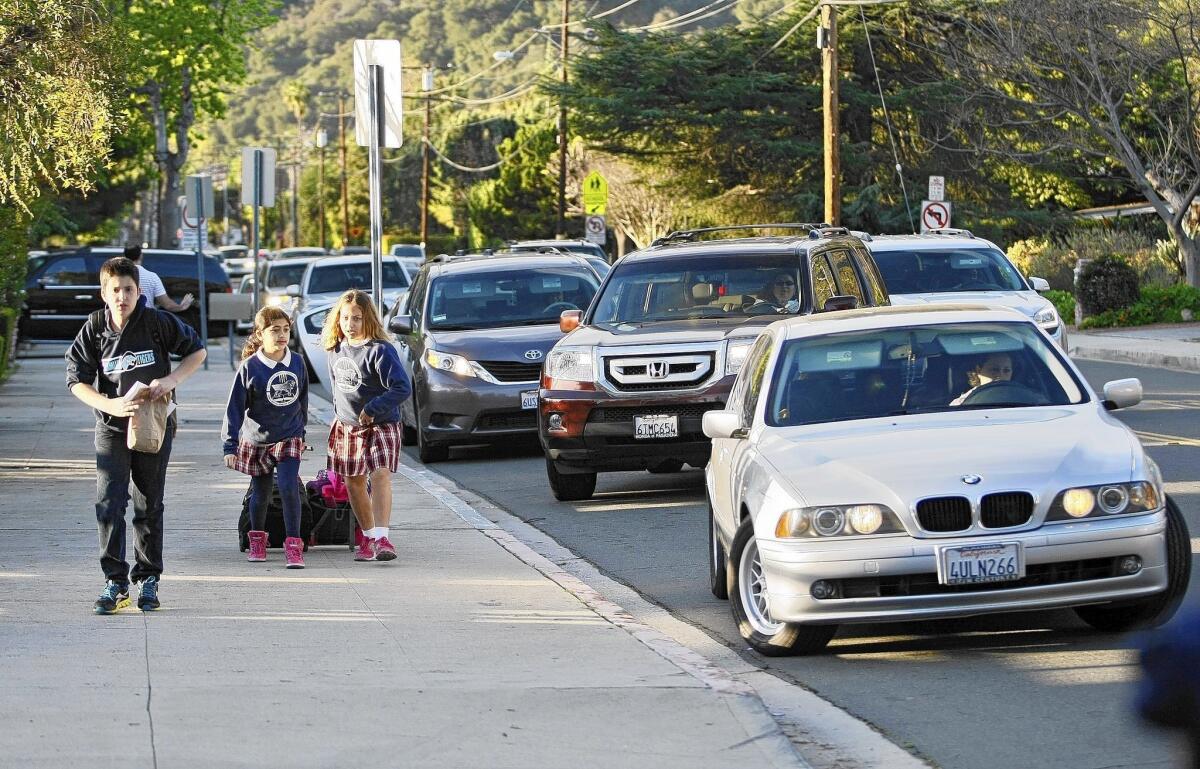 Parents in vehicles drop off their children at Chamlian Armenian School at about 8 a.m. on Tuesday, March 11, 2014.