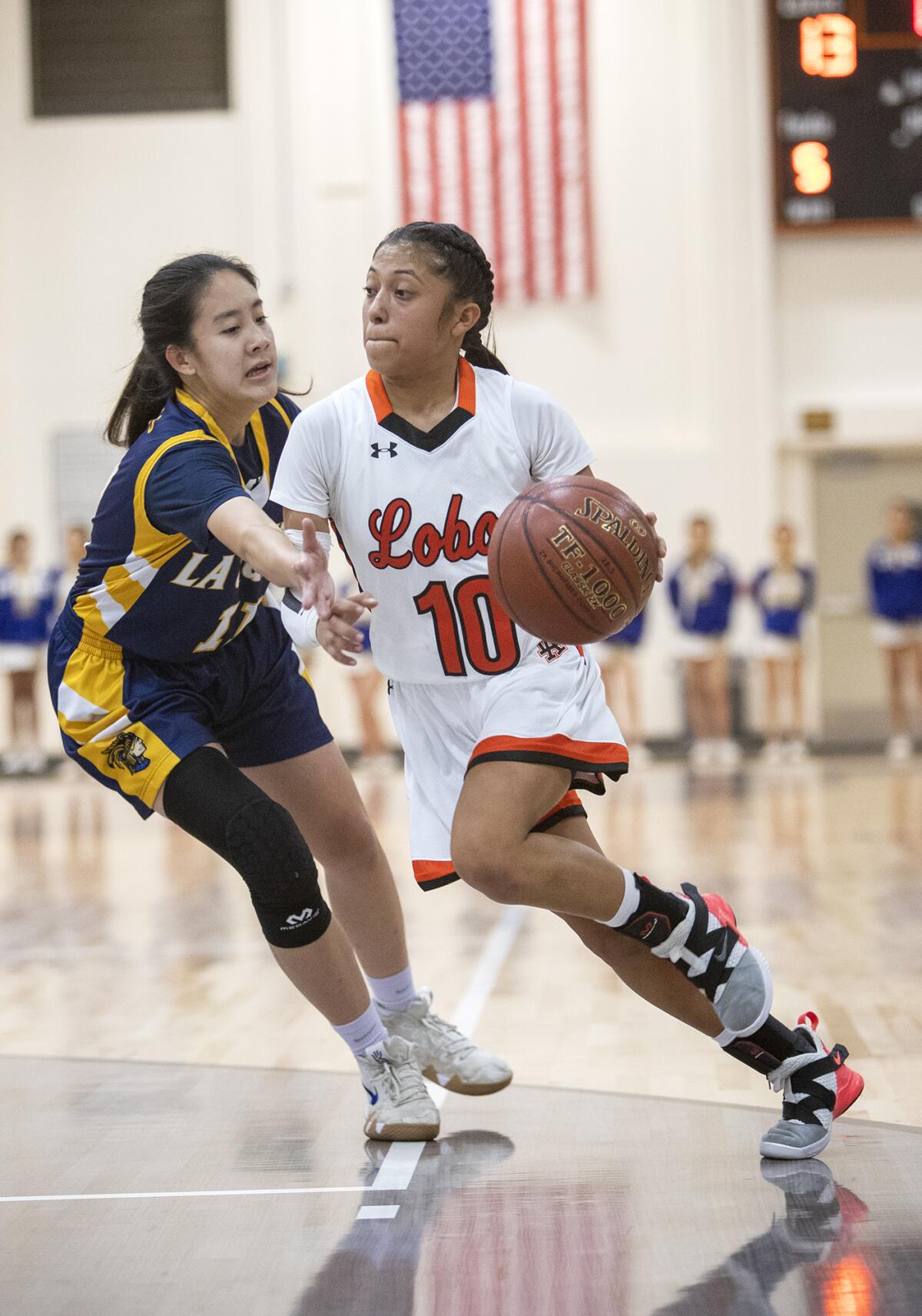 Los Amigos' Alexandra Lopez drives to the basket against La Quinta's Holly Nguyen during a Garden Grove League game on Friday.