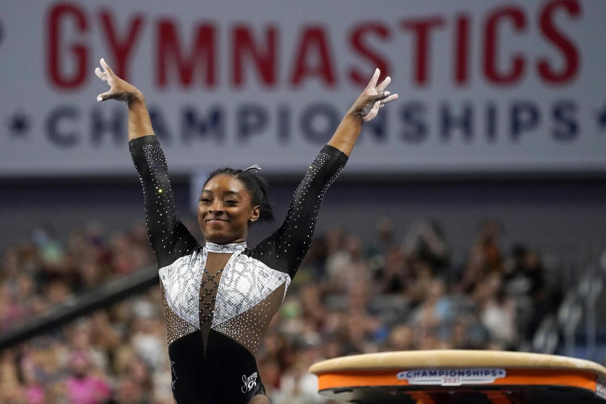 Simone Biles celebrates after competing in the vault.