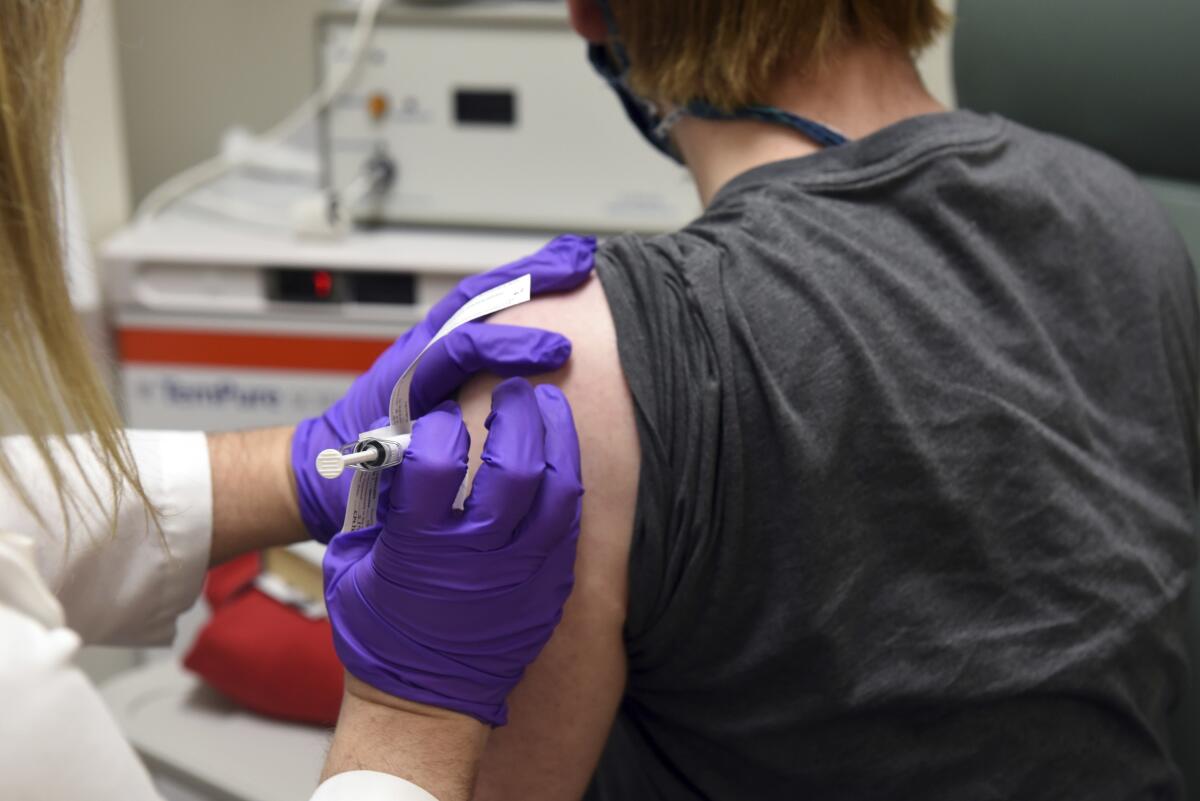 A patient enrolled in Pfizer's COVID-19 vaccine clinical trial receives an injection.