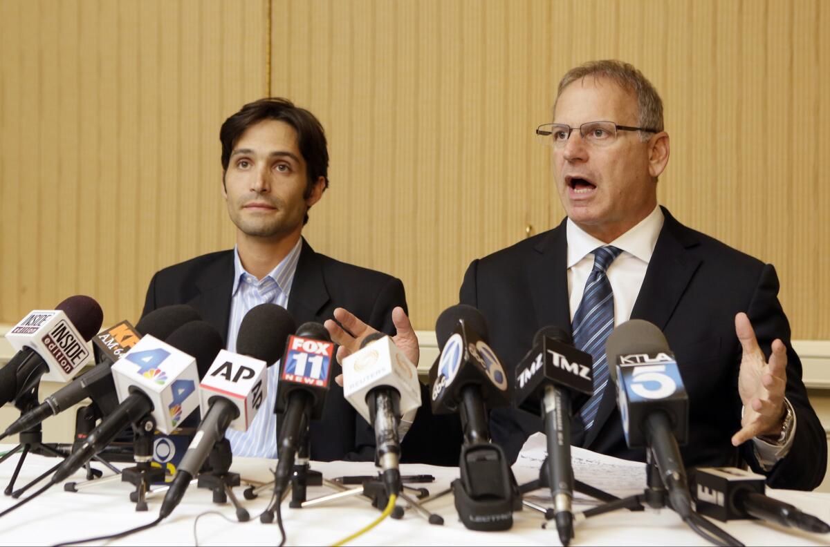 Plaintiff Michael Egan, left, and his attorney Jeff Herman attend a news conference.