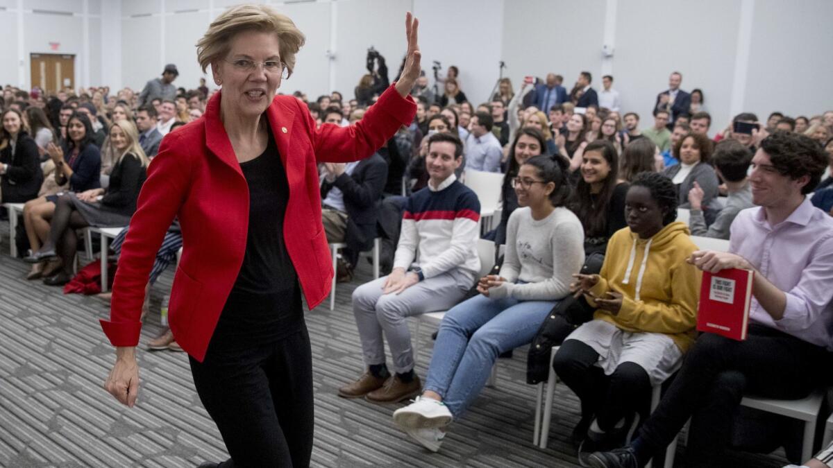 Sen. Elizabeth Warren, D-Mass., waves as she departs after speaking at the American University Washington College of Law on Nov. 29.