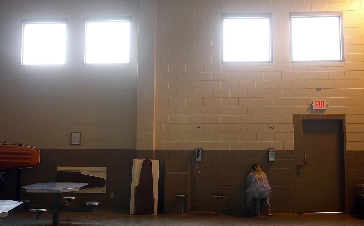 An inmate makes a call from a pay phone inside the Folsom Women's Facility. A state audit found that at least 39 female inmates underwent sterilization in which prison officials failed to follow proper procedures.