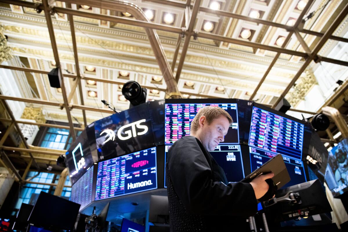 Traders work on the floor of the New York Stock Exchange