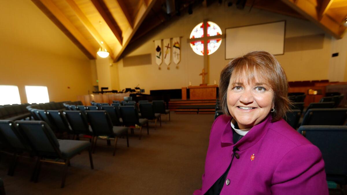 Bishop Karen Oliveto in the sanctuary of her church in Highlands Ranch, Colo. The United Methodist Church is reviewing whether she can remain in the post.