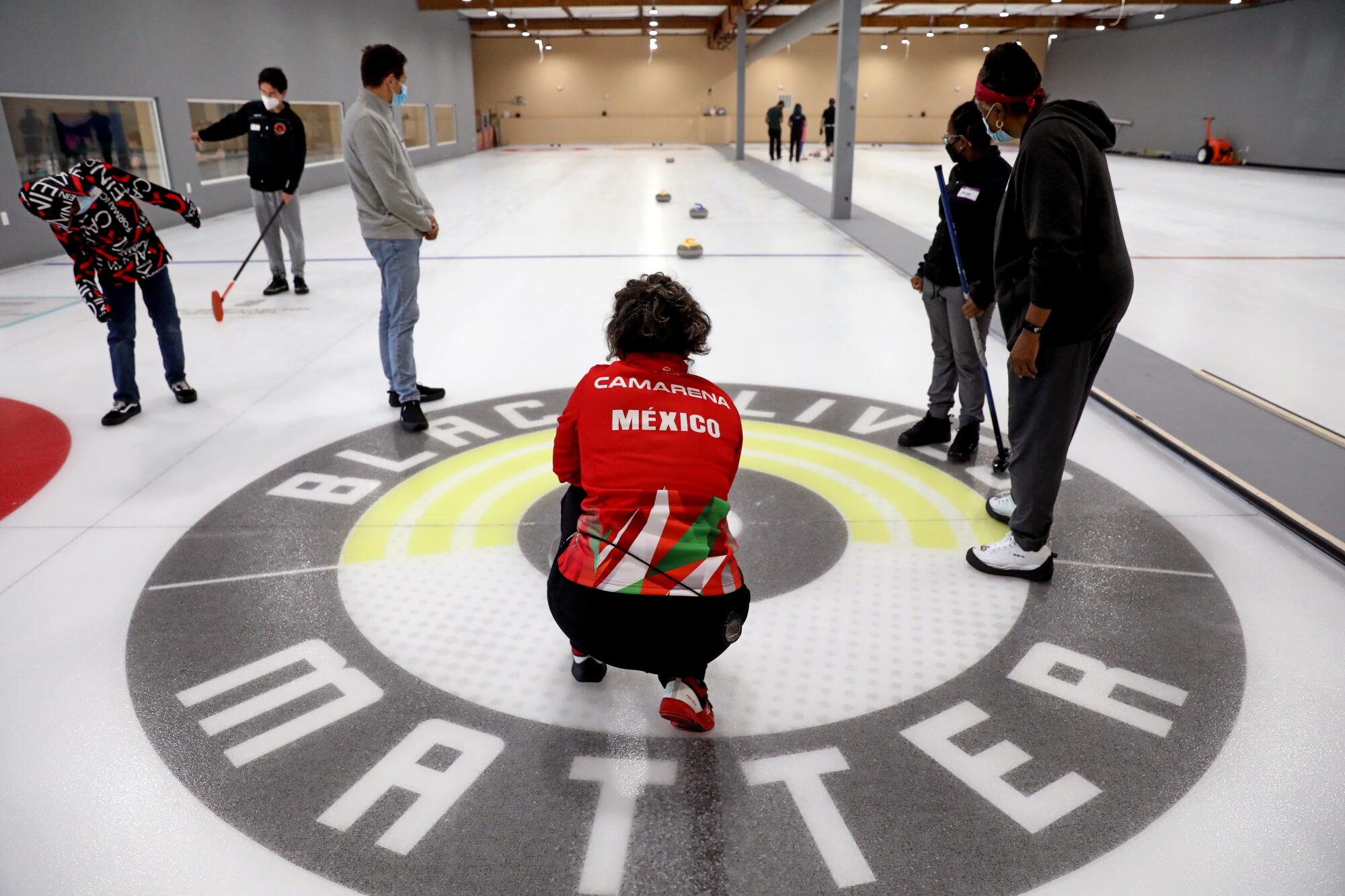 Instructor Adriana Camarena, 51, center, of San Francisco, who is a member of the Mexican curling team.