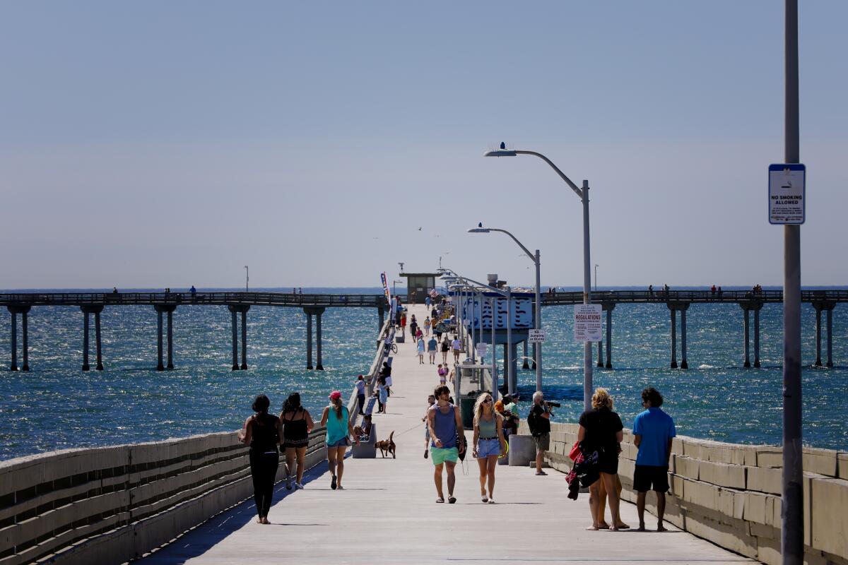 Residents walking down the Ocean Beach pier in June. 