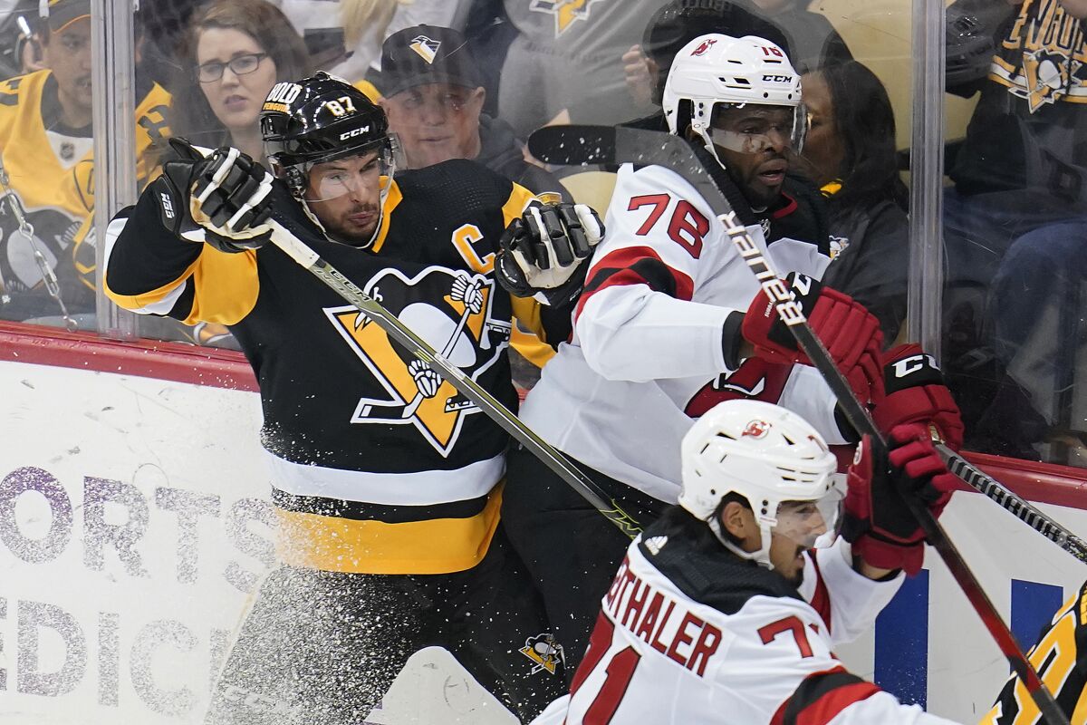 Pittsburgh Penguins' Sidney Crosby (87) collides with New Jersey Devils' P.K. Subban (76) during the first period of an NHL hockey game in Pittsburgh, Saturday, Oct. 30, 2021. (AP Photo/Gene J. Puskar)