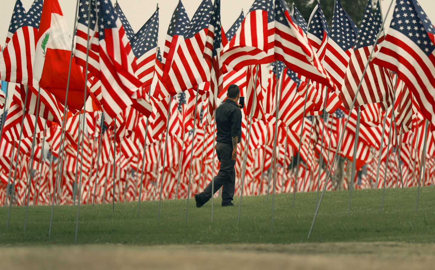 MALIBU, CA - SEPTEMBER 10: Rich Smith for his first time viewing the flags on Thursday as Pepperdine University for the 13th year is commemorating the lives lost in the terror attacks on September 11, 2001, with the Waves of Flags display at Alumni Park on the Malibu campus. In compliance with guidance provided by Los Angeles County due to the COVID-19 pandemic, the display will be closed to the public but spectators can view the display from the public sidewalk adjacent two the park. The installation commemorates the 2,977 lives lost in the terror attacks of September 11, 2001, featuring a vast display of American flags as well as international flags representing the home countries of those from abroad. Pepperdine University on Thursday, Sept. 10, 2020 in Malibu, CA. (Al Seib / Los Angeles Times