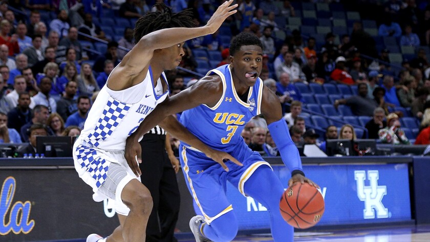 UCLA guard Aaron Holiday drives against Kentucky guard Shai Gilgeous-Alexander during the first half Saturday in New Orleans.