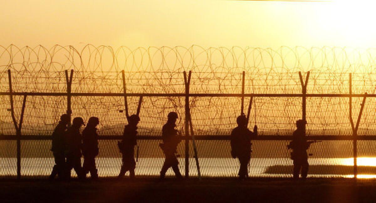 South Korean soldiers patrol along a fence near the border village of Panmunjom.