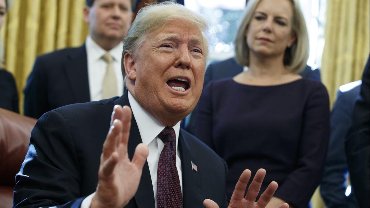 President Donald Trump answers a reporters question about the investigation of special counsel Robert Mueller during a signing ceremony of the "Cybersecurity and Infrastructure Security Agency Act," in the Oval Office of the White House, Friday, Nov. 16, 2018, in Washington. (AP Photo/Evan Vucci)