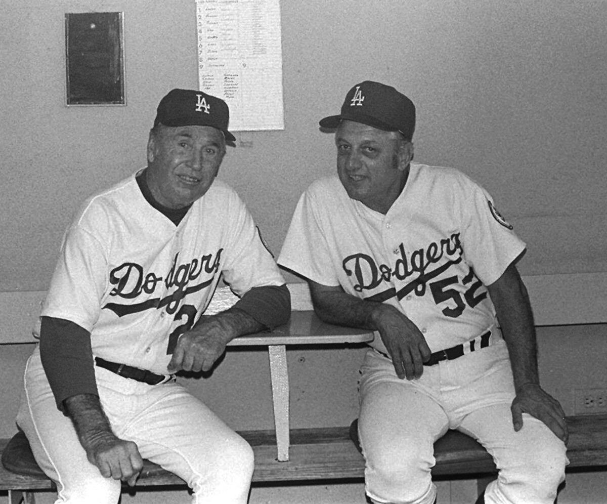 Manager Walter Alston, left, sits in the Dodgers dugout with Tommy Lasorda in 1976.