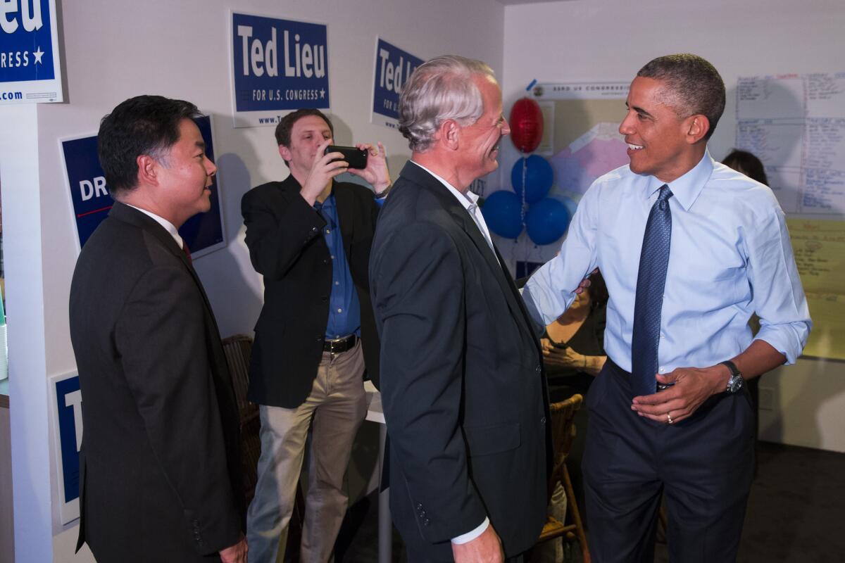 President Barack Obama, right, talks with Rep. Steve Israel (D-N.Y.) during a visit to the campaign office State Senator Ted Lieu, left, who is running for Congress.