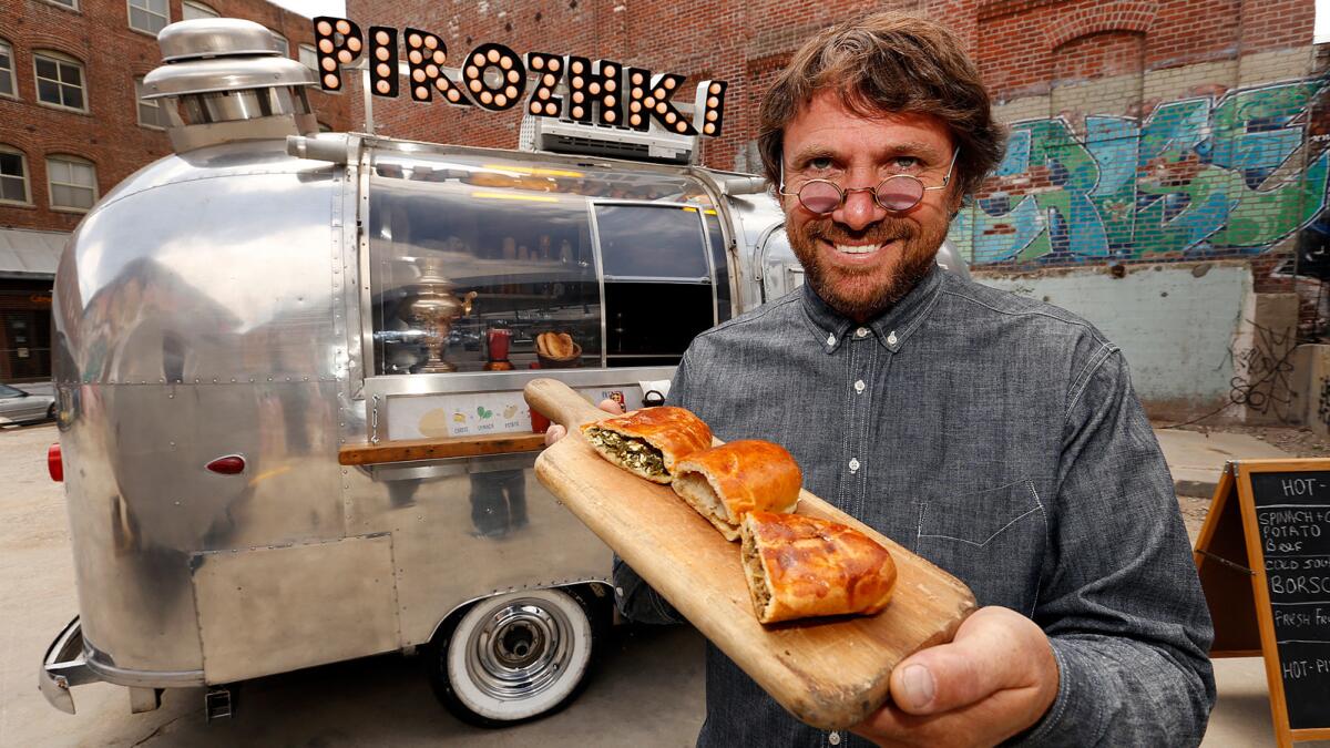 Igor Avramenko displays three kinds of pirozhki Russian bread buns outside his Pirozhki Airstream trailer in the courtyard of the Hauser Wirth & Schimmel gallery.