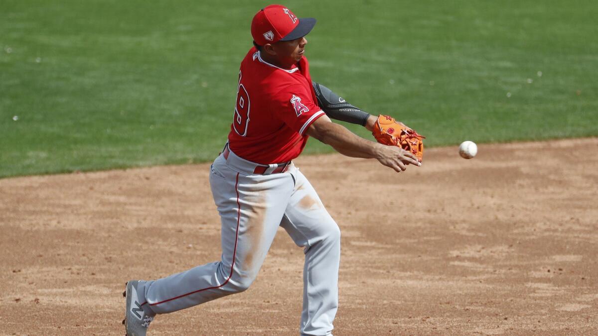 The Angels’ Wilfredo Tovar makes a defensive play against the Kansas City Royals during the third inning of a spring training baseball game.