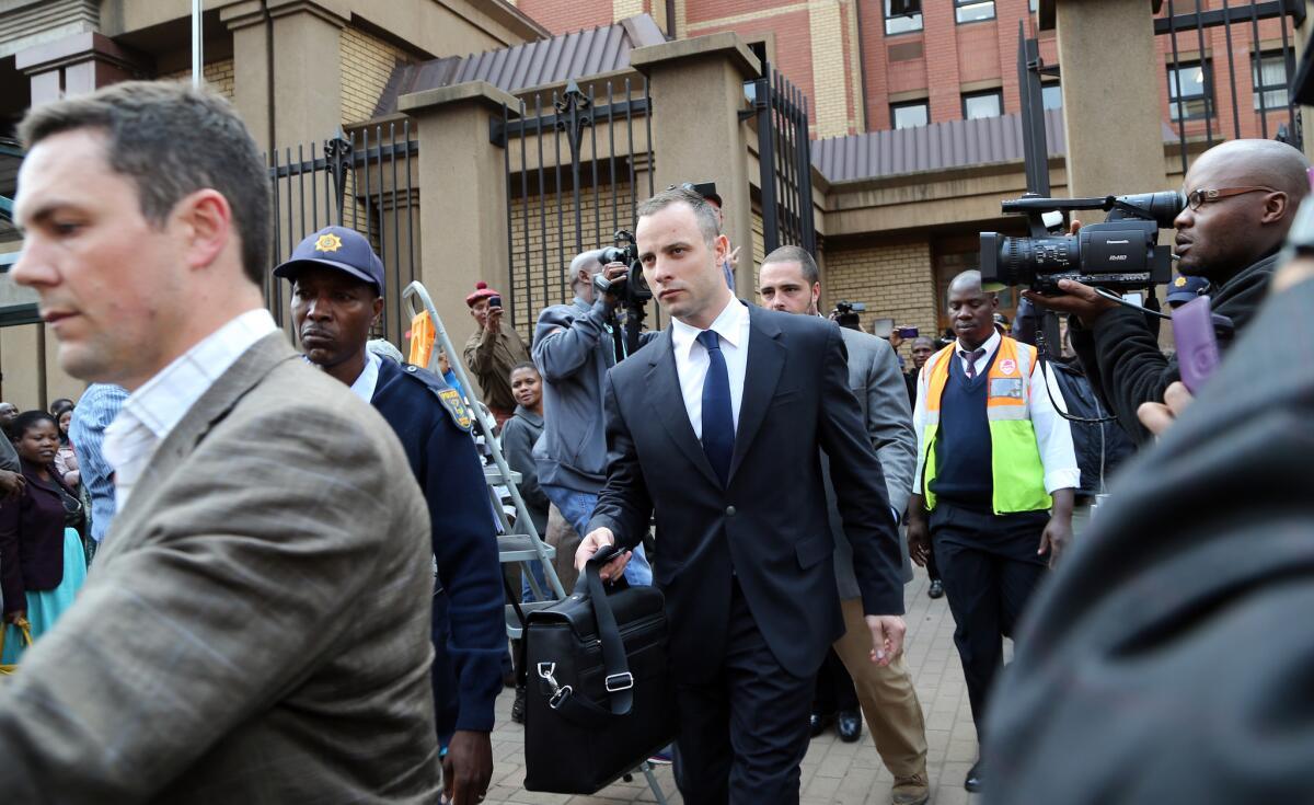 Oscar Pistorius, center, leaves court after his trial adjourned for the day in Pretoria, South Africa. Pistorius is charged with murder in the shooting death of his girlfriend, Reeva Steenkamp, on Valentine's Day 2013.