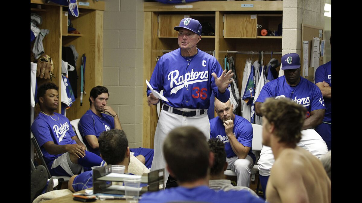 Ogden Raptors Manager John Shoemaker (center) talks to his players before a game against Montana on July 17.