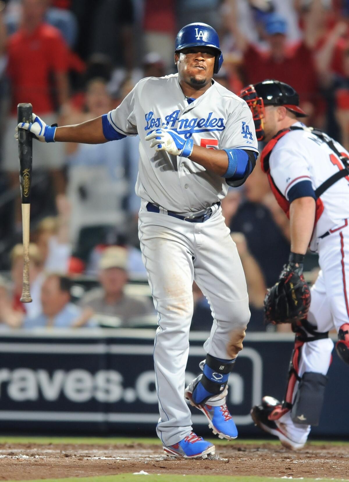 Dodgers third baseman Juan Uribe strikes out with two runners on base during the sixth inning of the Dodgers' 4-3 loss to the Atlanta Braves in Game 2 of the National League division series Friday.