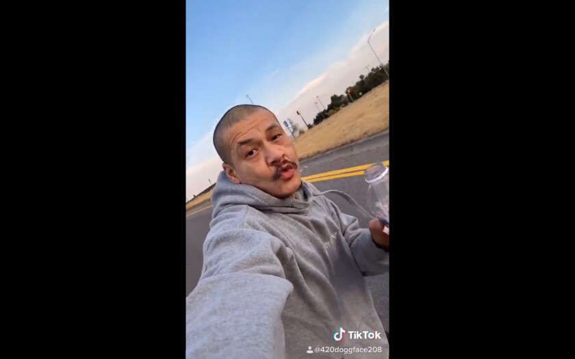 Nathan Apodaca, on a skateboard and holding a drink, films himself for TikTok.