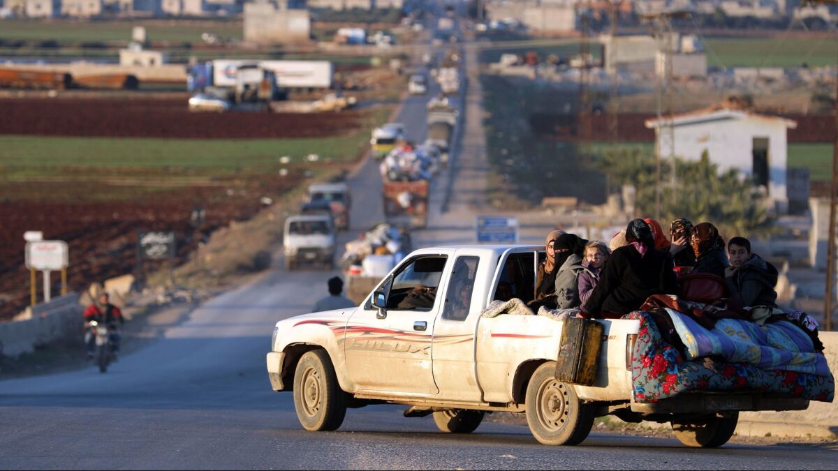 Displaced Syrians who fled the fighting in Idlib province drive on a road in a rebel-held area near the city of Saraqib on Jan. 7, 2018.