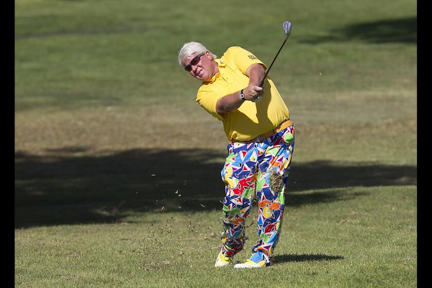 Colorful crowd favorite John Daly hits his approach shot on the 9th hole of the Toshiba Classic final round at the Newport Beach Country Club on Sunday.
