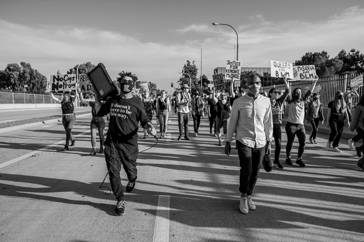 Andre Henry, left, participates in a Black Lives Matter march in Pasadena in 2020.