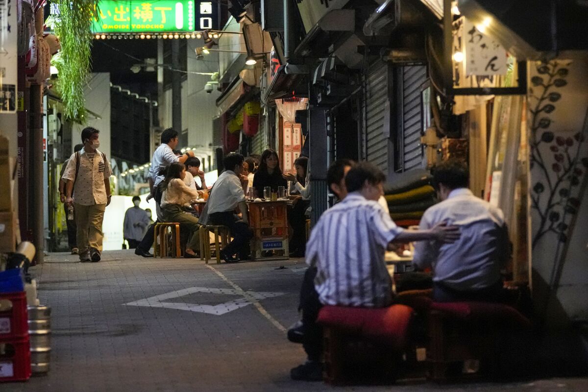 People sitting outside at bars and restaurants in Tokyo