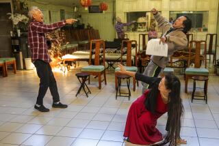 ROWLAND HEIGHTS, CA-DECEMBER 9, 2023:Executive producer Tuen-Ping Yang, left, standing in for the part of the murderer, rehearses a scene with Kaidy Kuna as Ahgen and Lee Chen as Linda for the English version of a play about the mass shooting at the Star Ballroom Dance Studio in Monterey Park. (Mel Melcon/Los Angeles Times)