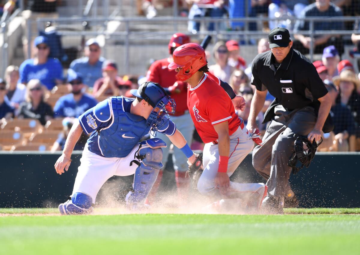 Angels' Michael Hermosillo is tagged out at home plate by the Dodgers' Will Smith during the fourth inning of a spring training game at Camelback Ranch on Wednesday in Phoenix.