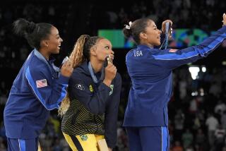 Gold medalist Rebeca Andrade, center, of Brazil, celebrates on the podium between silver medalist Simone Biles, left, and bronze medalist Jordan Chiles, both of the United States, during the medal ceremony for the women's artistic gymnastics individual floor finals at Bercy Arena at the 2024 Summer Olympics, Monday, Aug. 5, 2024, in Paris, France. (AP Photo/Abbie Parr)