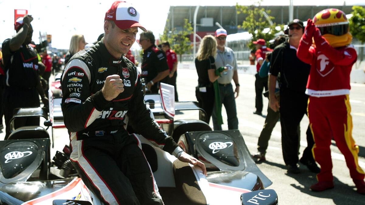 Will Power celebrates Saturday after winning the starting pole position at the IndyCar race in Toronto.
