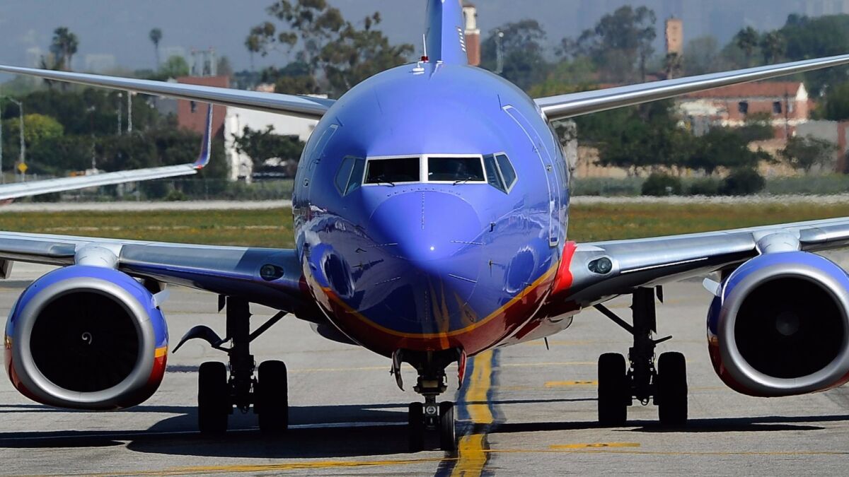 A Southwest Airlines Boeing 737-700 passenger jet taxis on the tarmac after arriving at Los Angeles International Airport. A University of Virginia study finds that the airline still has the power to force competitors to lower their fares when it enters a market.
