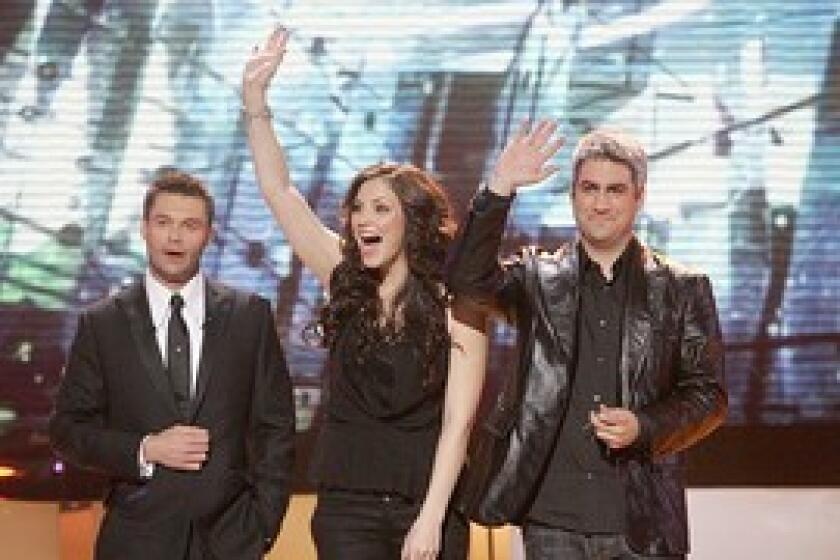 Host Ryan Seacrest, left, with season 5's pair of finalists, Katherine McPhee and eventual champion Taylor Hicks.
