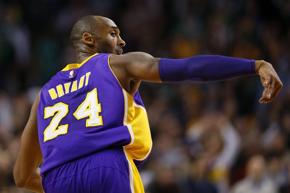 Kobe Bryant heads back up court after making a shot against Boston on Dec. 30.
